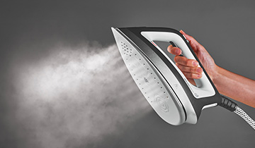 The image shows the powerful of the Polti Vaporella Instant's steam, escaping from its soleplate