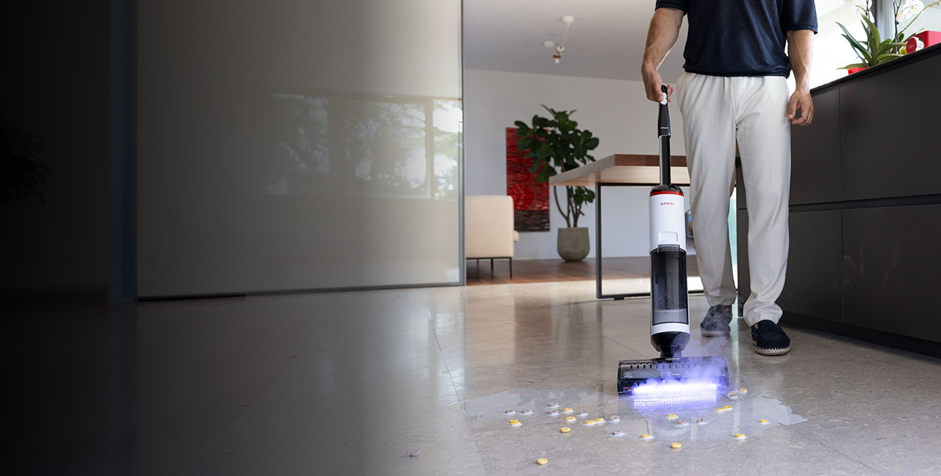 A girl using Polti Rollysteam cleaning the wood floor